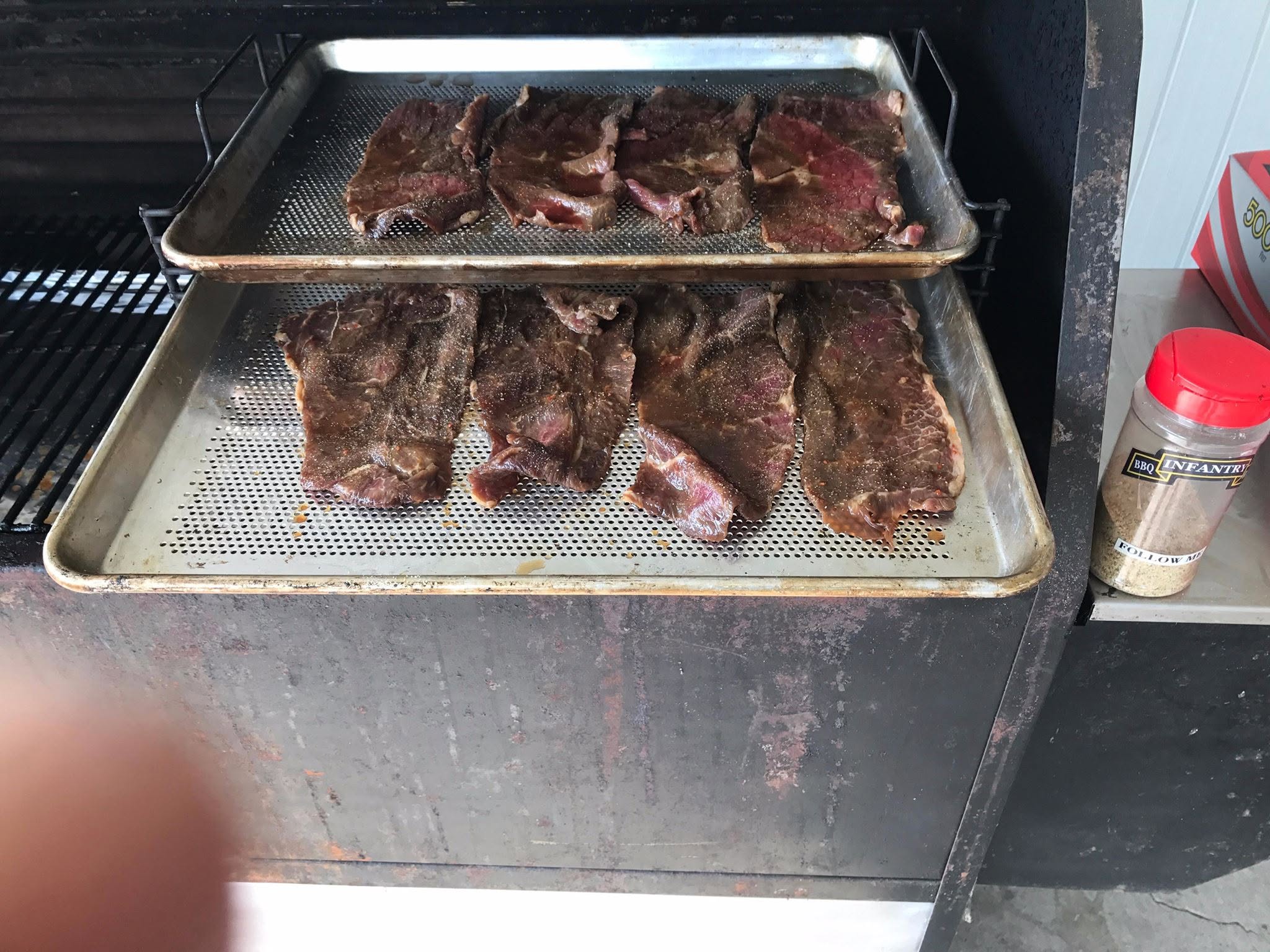 Beef jerky drying across Bull Rack perforated trays